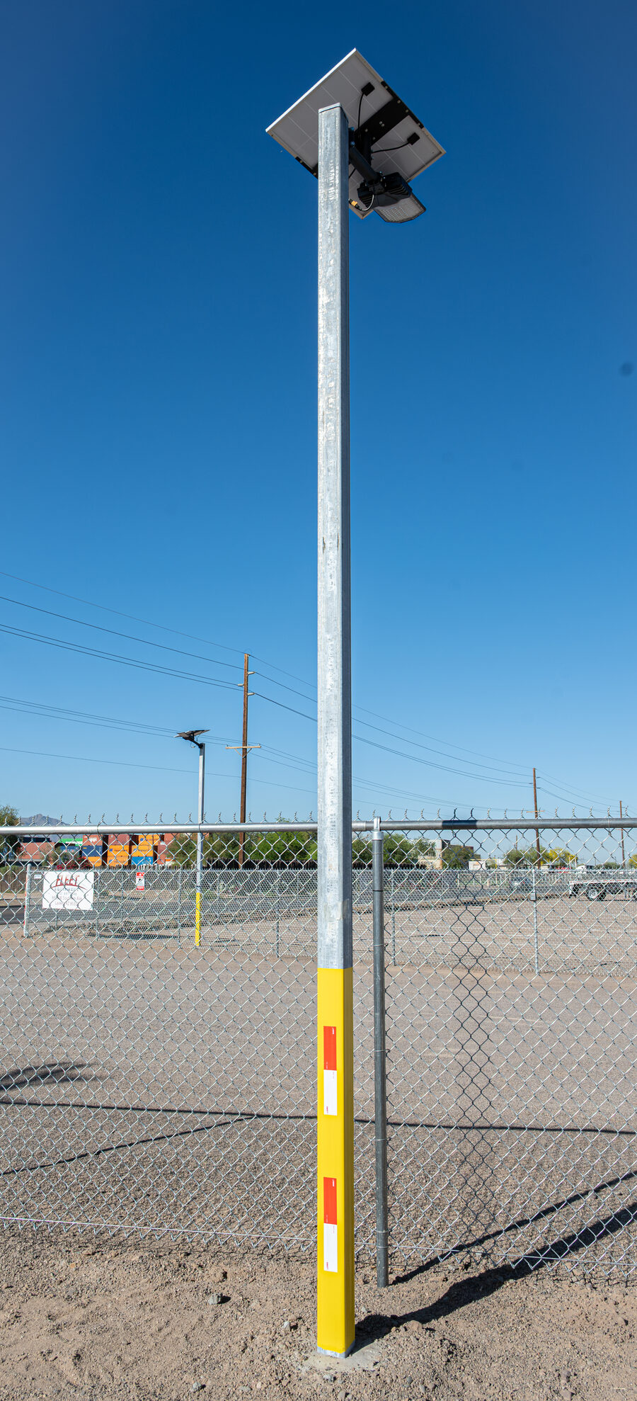 Solar security light on industrial fence Arizona