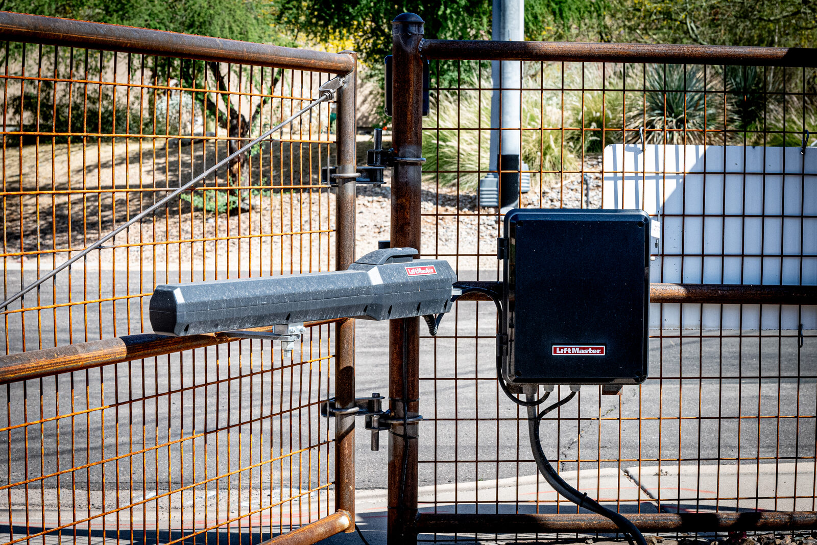 Commercial swing-arm gate operator on a fence in Arizona Commercial swing-arm gate operator on a fence in Arizona